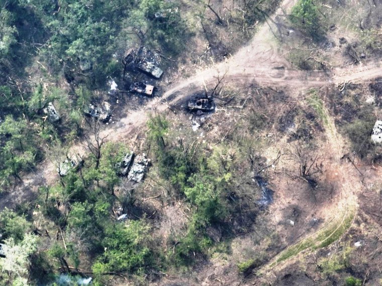 Images released by Ukrainian armed forces appear to show Russian tanks destroyed along a dirt track by the river. 