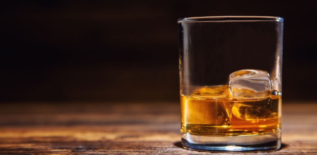  A Glass of Whiskey on a wooden table