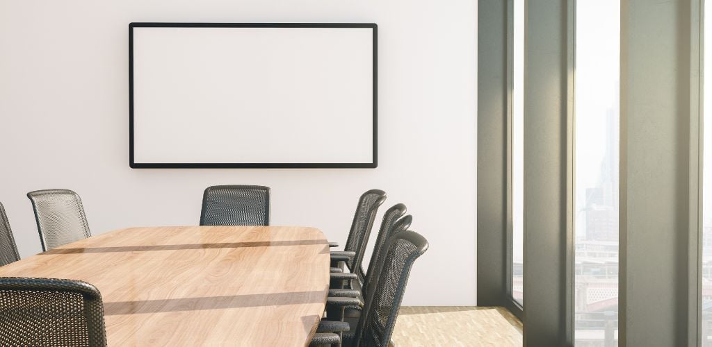 meeting room with table and chairs, large windows and city view 