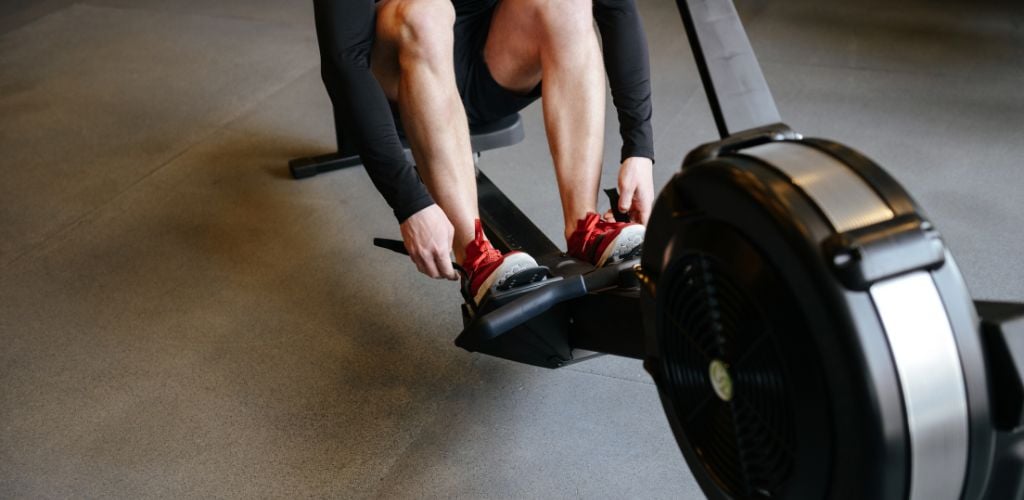 in-house gym, working out on rowing machine