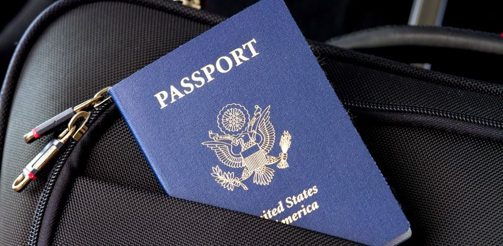 USA passport tucked into backpack 