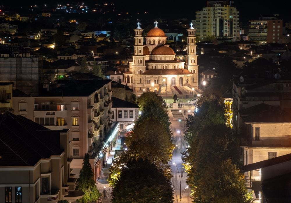 A view from above of the main pedestrian street in Korce, Albania at night going to the Resurrection of Christ Orthodox Cathedral.