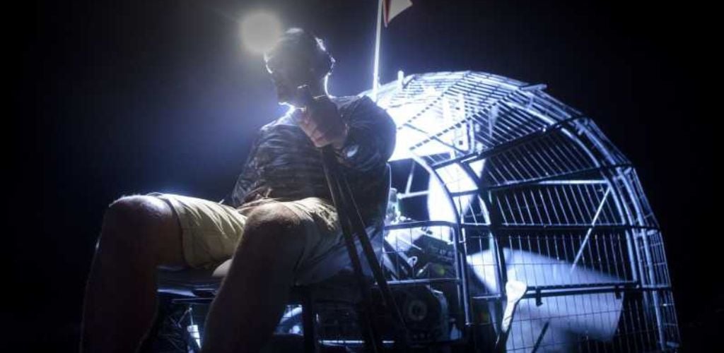 A man driver an airboat at night tour. 