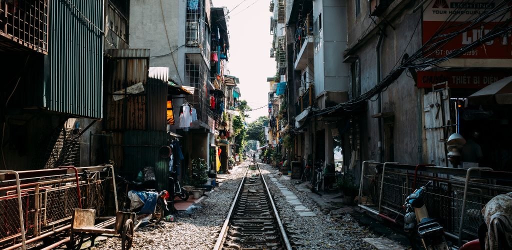 Vietnam railroad, passing through narrow building passageway 