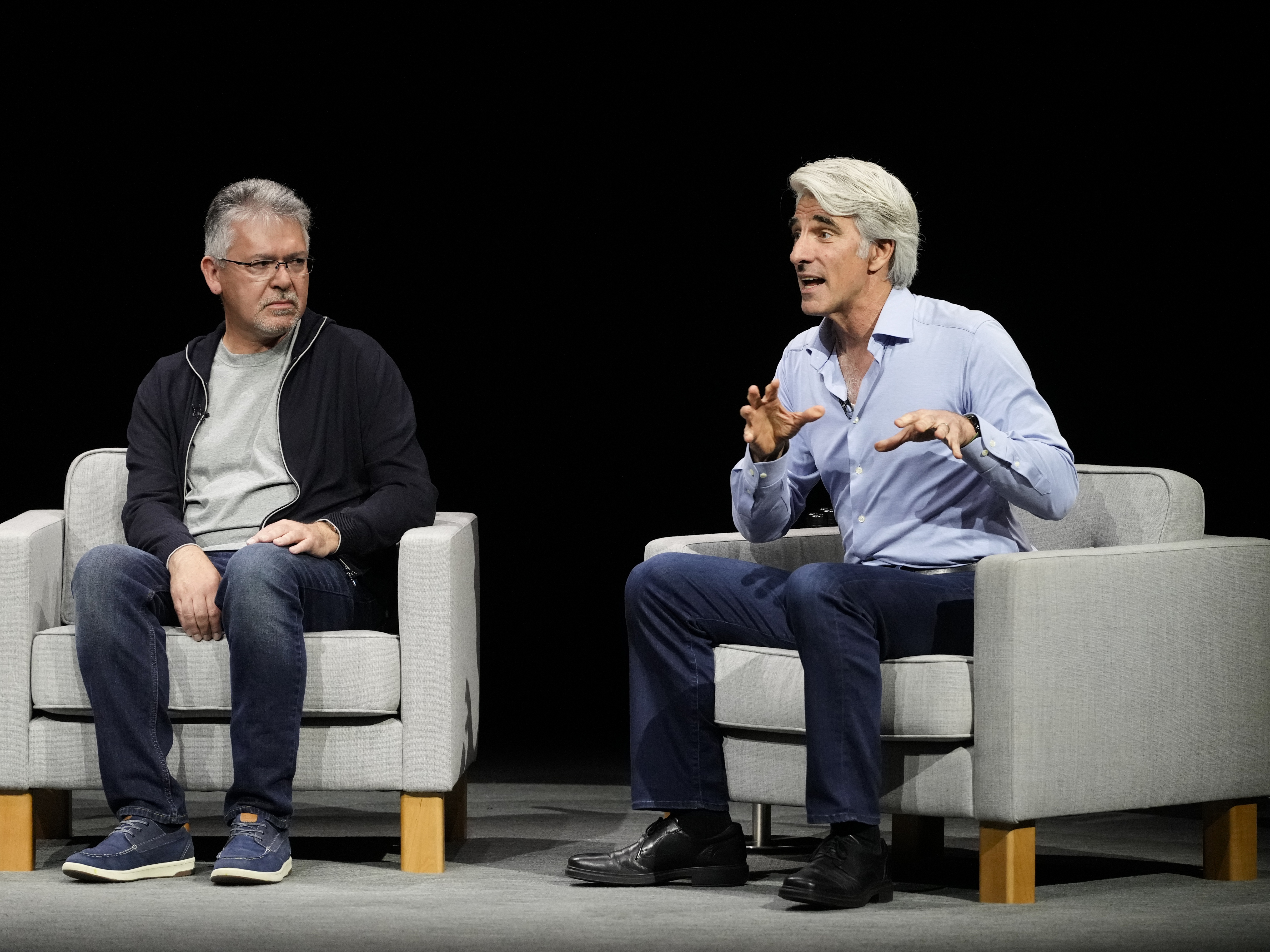 Apple software chief Craig Federighi, right, pictured with exec John Giannandrea, announced a partnership with OpenAI to bring AI features to its products. (AP Photo/Jeff Chiu)
