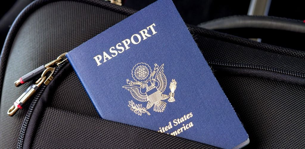 USA passport tucked into backpack