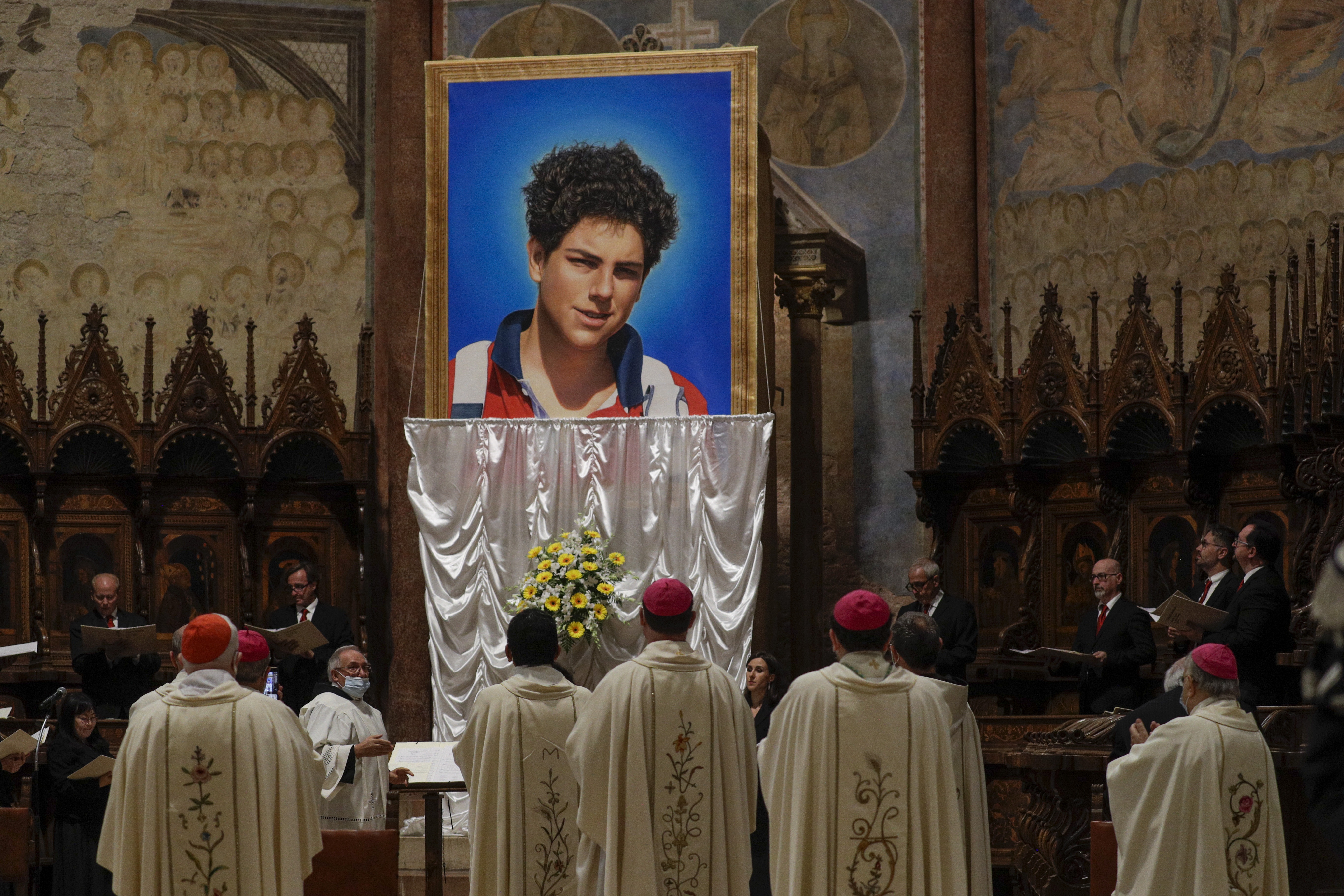 An image of 15-year-old Carlo Acutis is unveiled during his beatification ceremony at the St. Francis Basilica in Assisi, Italy, in October 2020. 