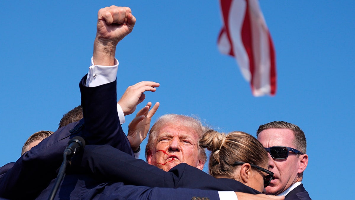 Republican presidential candidate former President Donald Trump is surrounded by U.S. Secret Service agents at a campaign rally