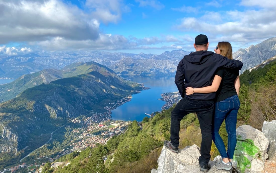 a picture of Nick and Dariece from Goats On The Road looking at a view over mountains