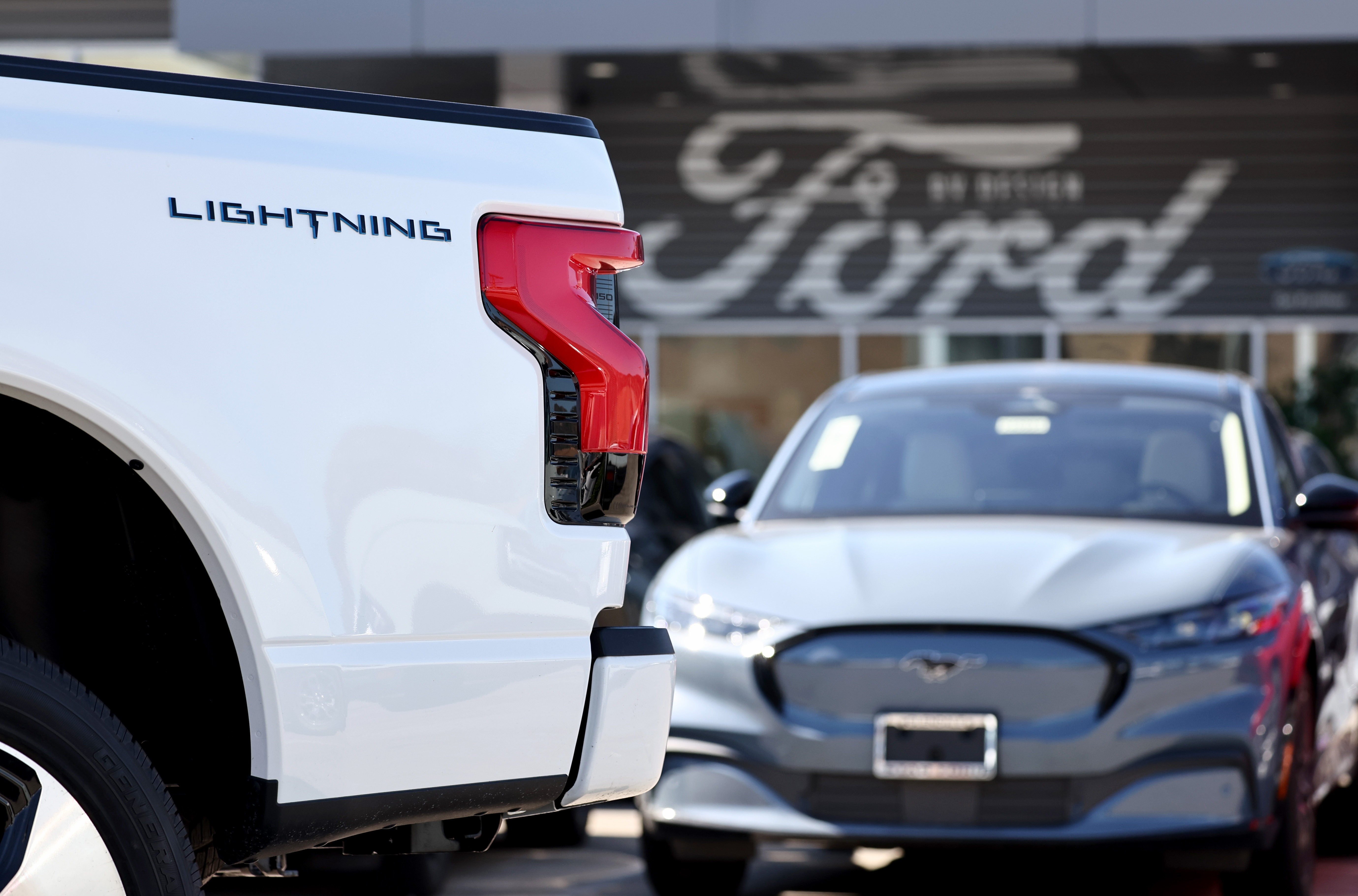 A Ford F-150 Lightning electric pickup truck is displayed for sale at a Ford dealership on Aug. 21 in Glendale, Calif. Ford says it is upending its electric vehicle strategy for North American vehicles to focus on hybrids, citing consumers