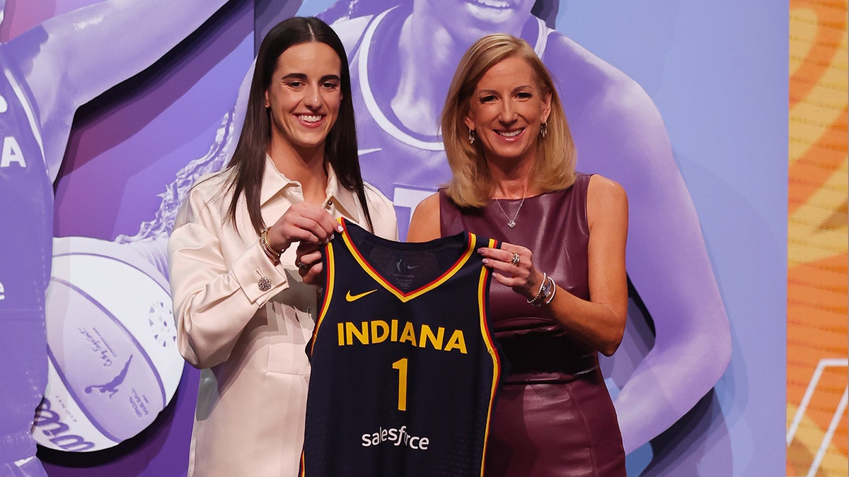 Caitlin Clark poses for a photo at the WNBA Draft