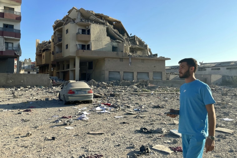 A man walks past destruction caused by Israeli airstrikes on the outskirts of Tyre, Lebanon, on Sept. 26, 2024.