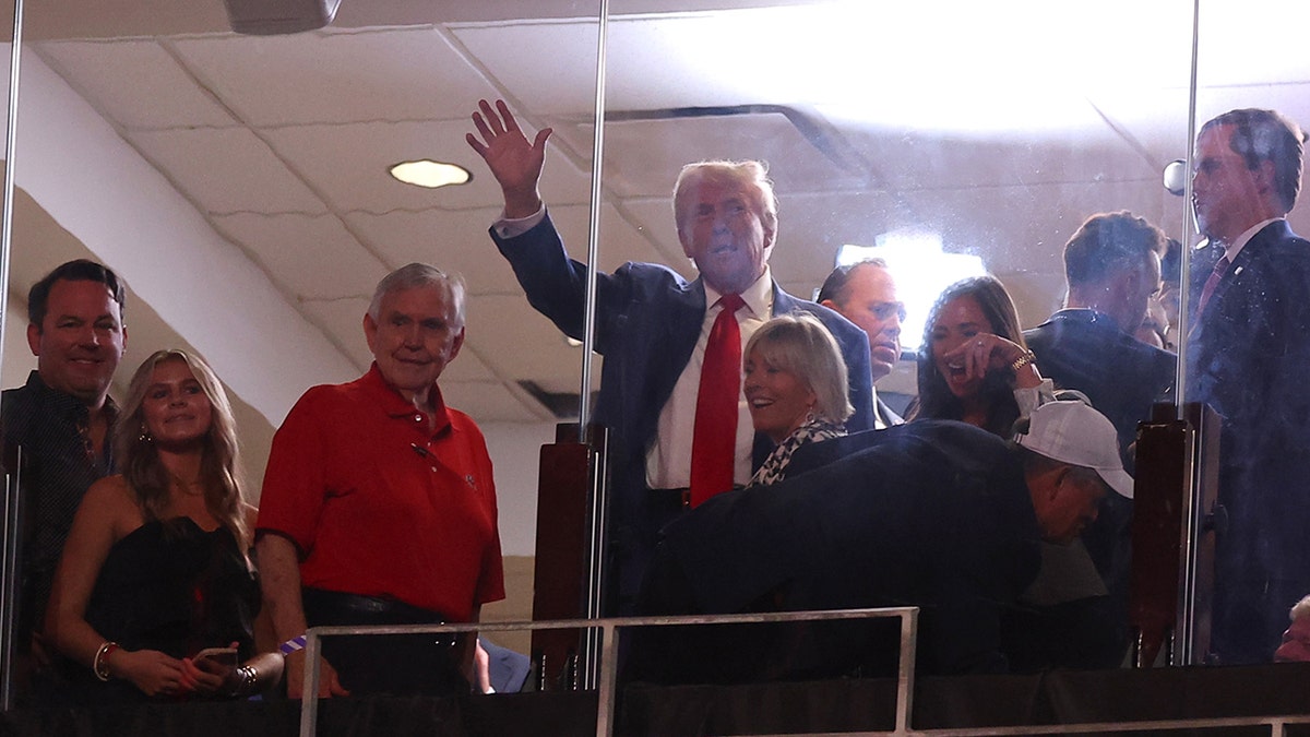 Trump waving in suite