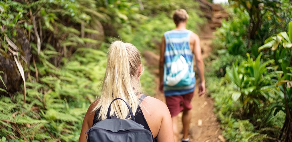 Couple on a Hike surrounded by lush greenery