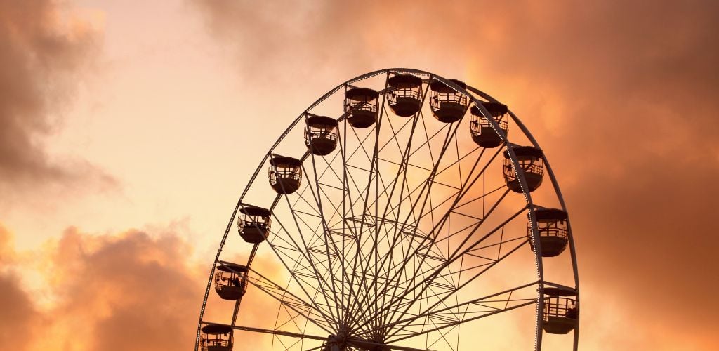 ferris wheel at dusk, twilight sky in background