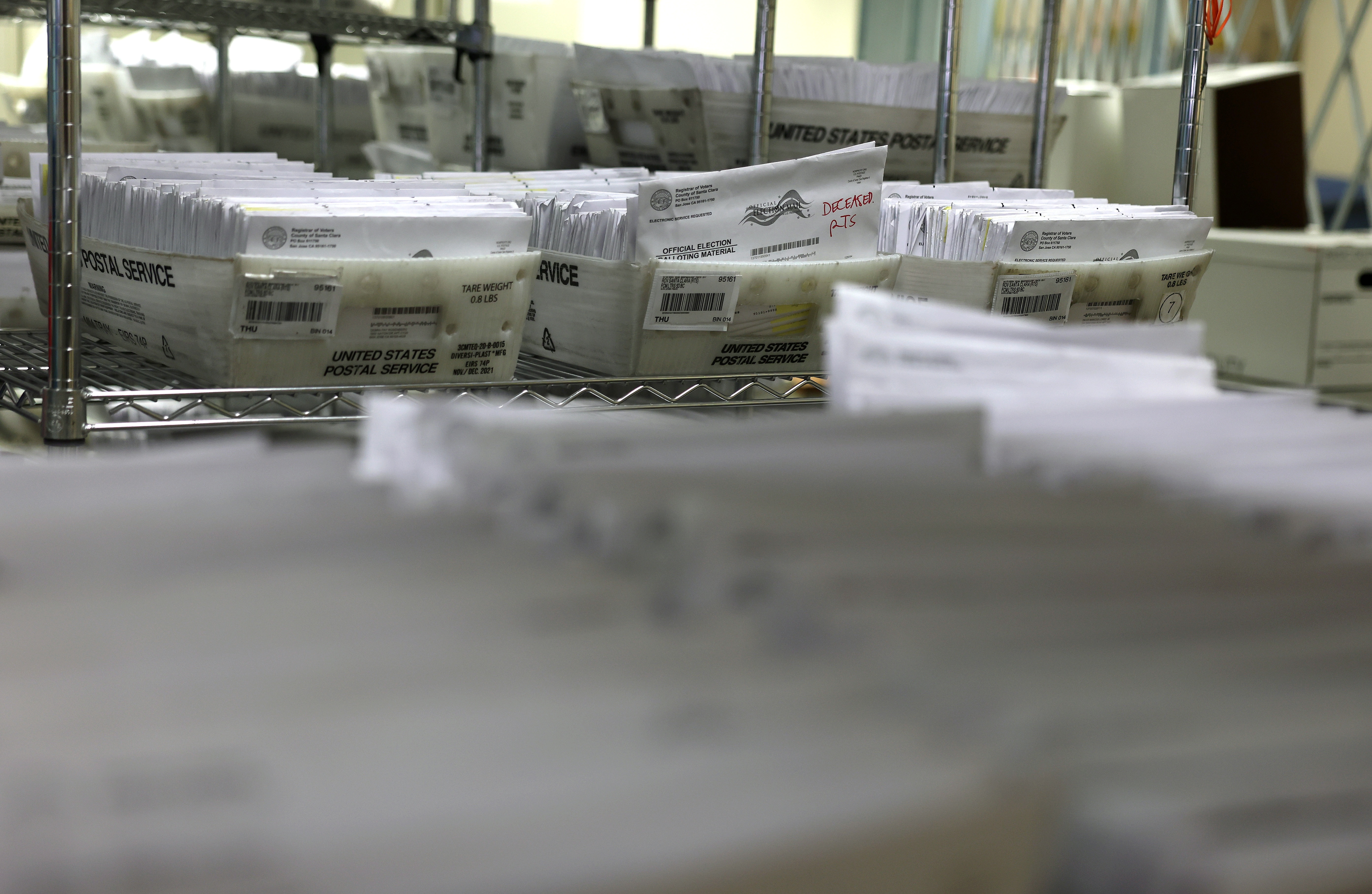 Trays of mail in ballots are stacked at the Santa Clara County Registrar of Voters office on Oct. 21, 2024 in San Jose, Calif.