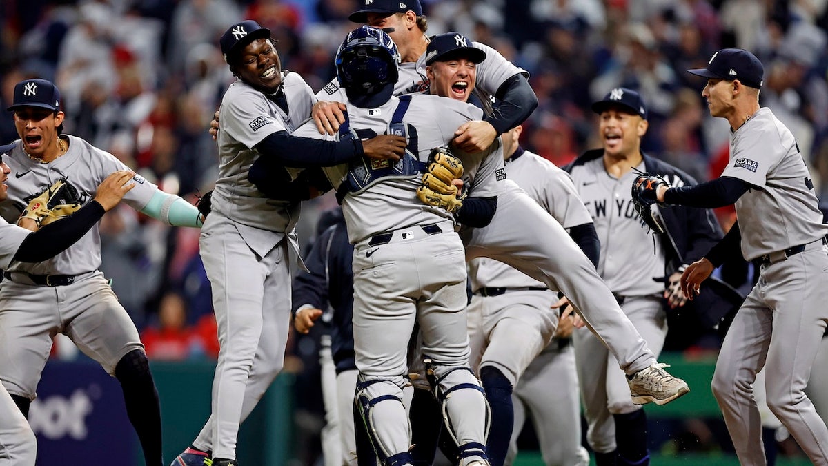 The New York Yankees celebrates after beating the Cleveland Guardians during game five of the ALCS for the 2024 MLB playoffs at Progressive Field. Mandatory Credit: Scott Galvin-Imagn Images