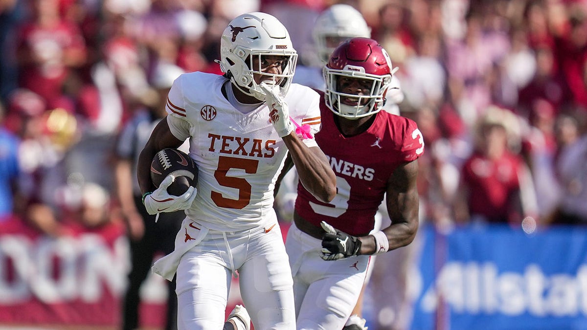 Texas Longhorns football player runs for a first down