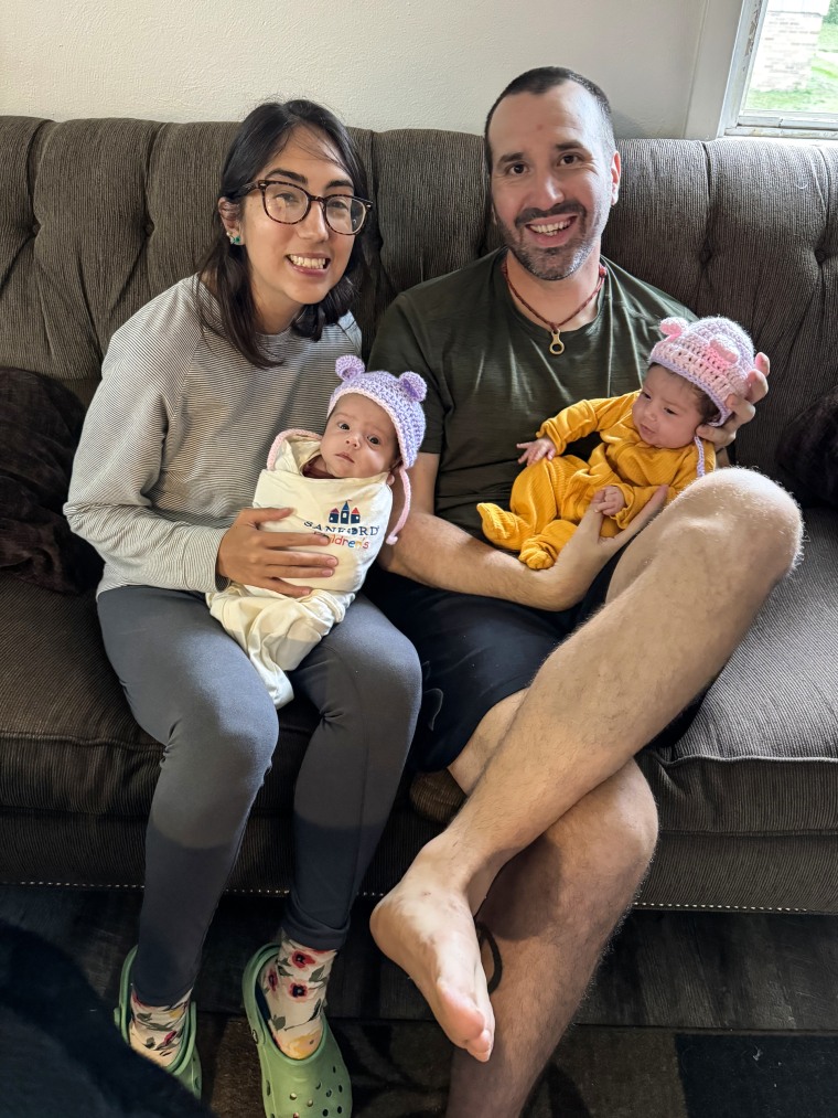 Wesley Bruce and Ashley Perez hold their twins.