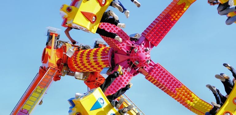 People riding a claw-looking ride in an amusement park