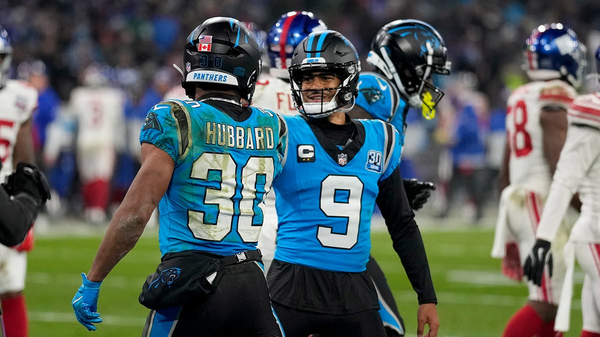 Chuba Hubbard and Bryce Young celebrate