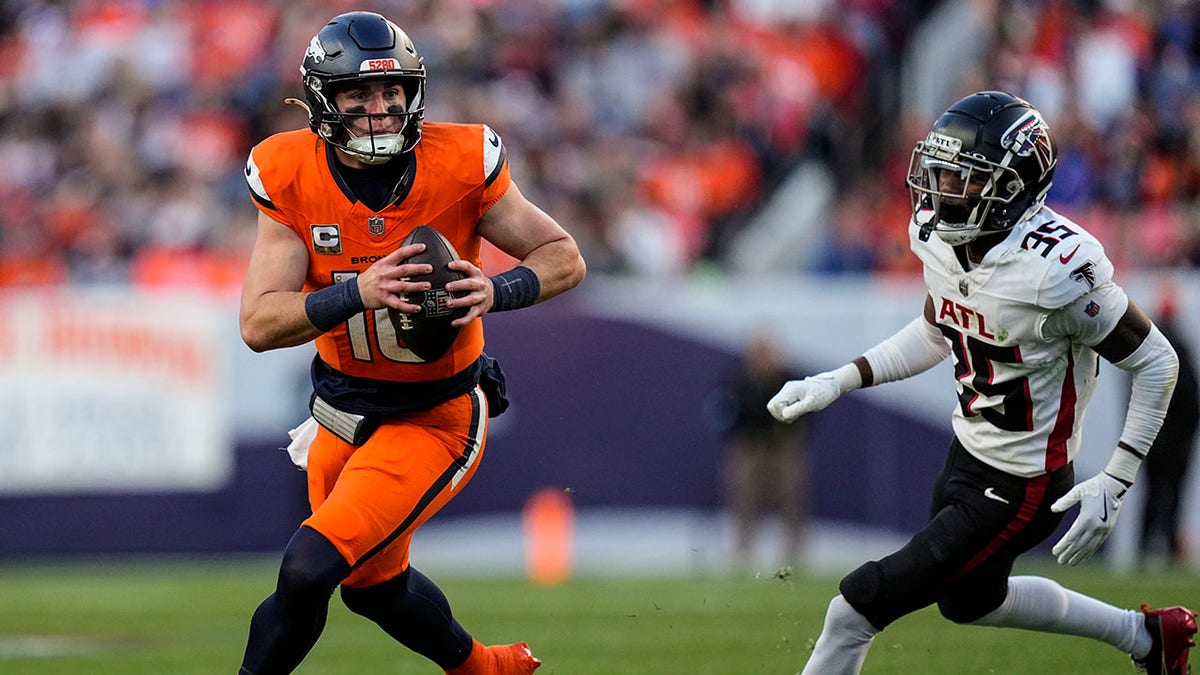 Broncos quarterback Bo Nix (10) runs as Atlanta Falcons cornerback Natrone Brooks pursues during the second half of an NFL football game, Sunday, Nov. 17, 2024, in Denver. (AP Photo/Jack Dempsey)