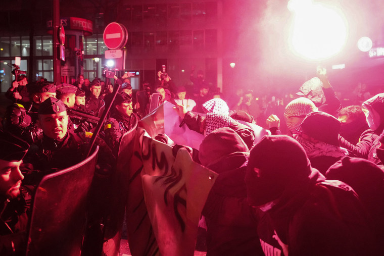 Protesters clash with French Gendarmes during a rally against the "Israel is Forever" gala organized by far-right Franco-Israeli figures, in Paris on Wednesday night. 