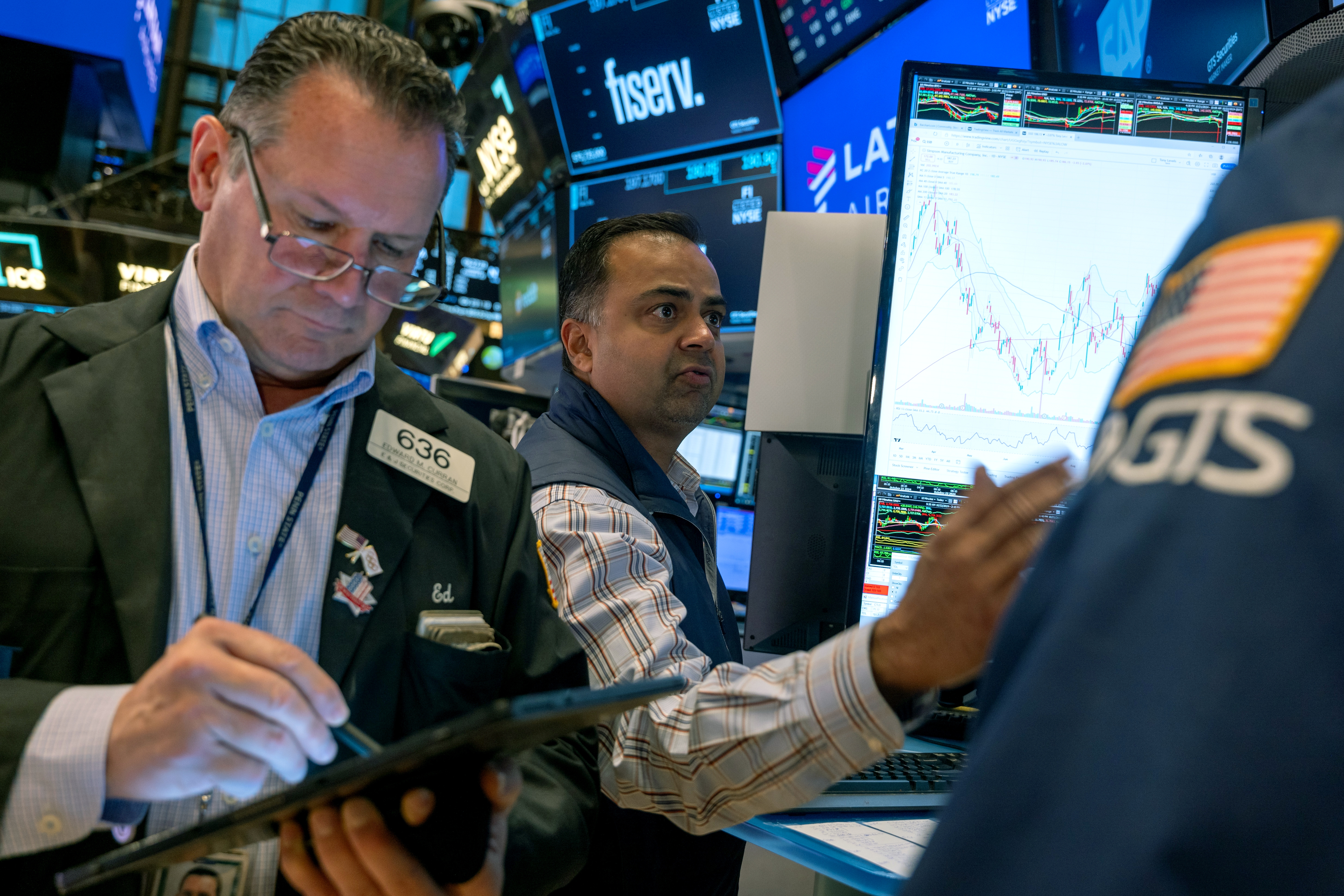 Stocks and cryptocurrencies surged after former President Trump won the presidential election. Pictured are traders working on the New York Stock Exchange in New York on Oct. 22.