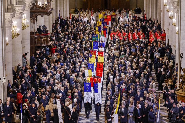 Guests stand as Church Banners are paraded.