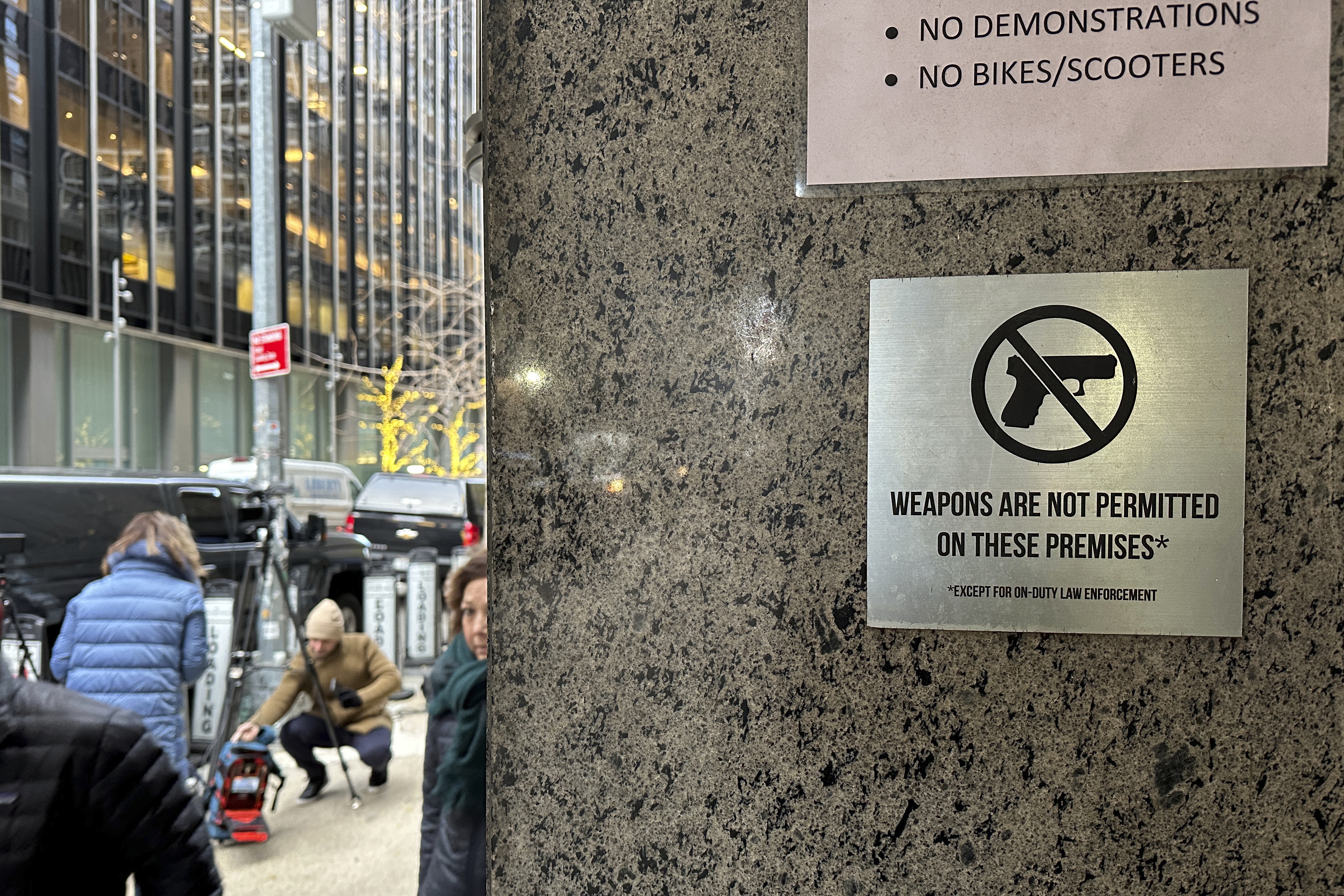 A no guns allowed sign is posted at the 54th Street entrance to the New York Hilton Midtown Hotel in New York, where Brian Thompson, the CEO of UnitedHealthcare, was fatally shot last week.