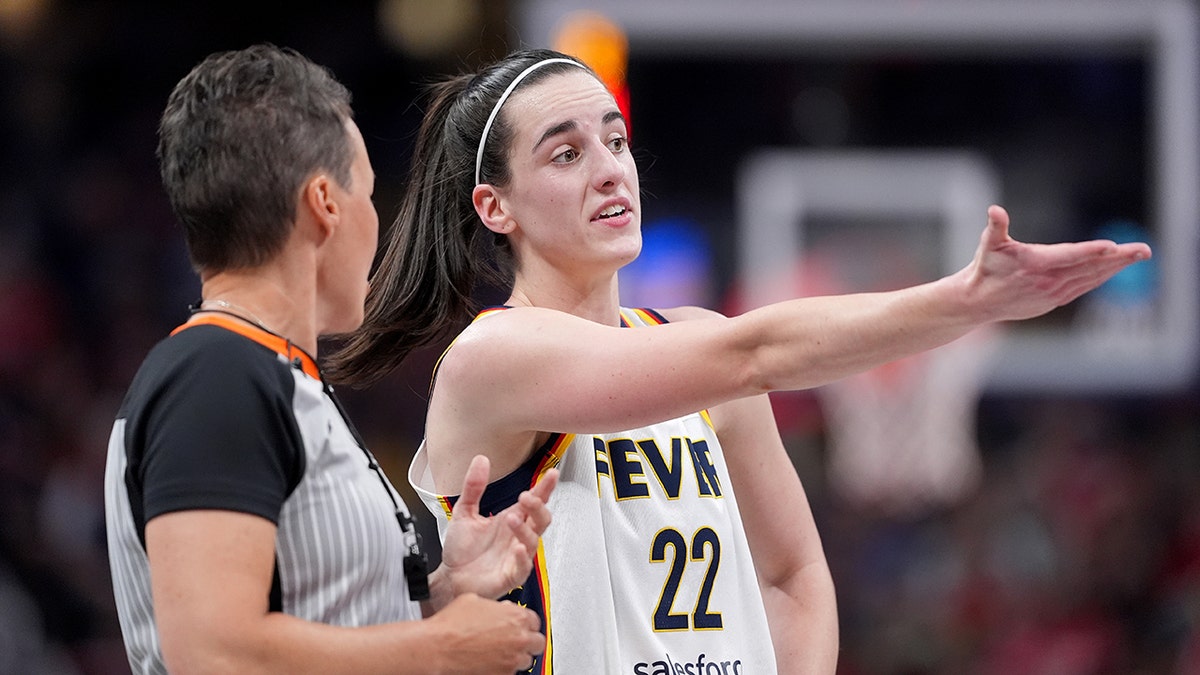 Caitlin Clark argues with a referee