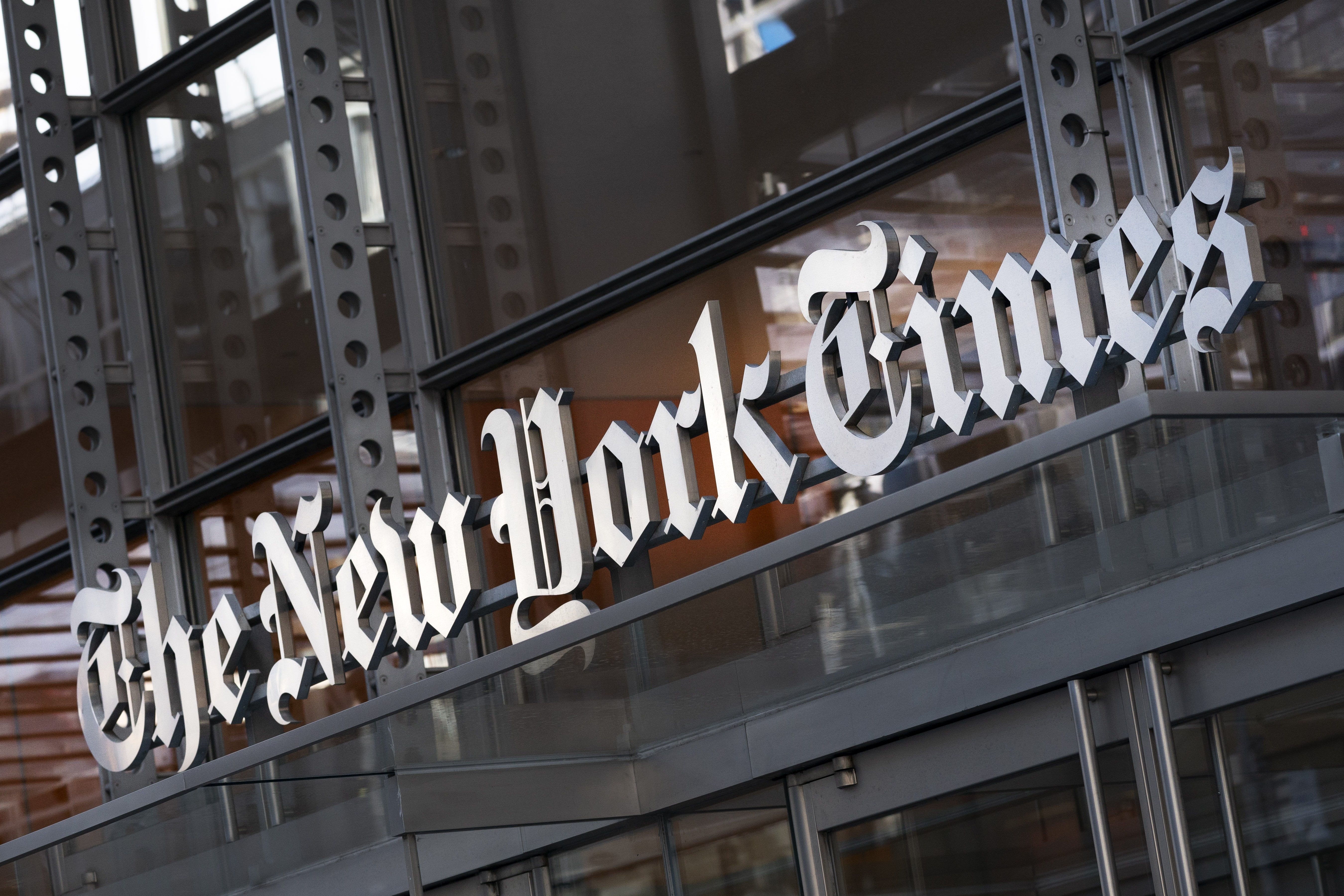 A sign for The New York Times hangs above the entrance to its building, Thursday, May 6, 2021, in New York. The New York Times filed a federal lawsuit against OpenAI and Microsoft on Wednesday, Dec. 27, 2023, seeking to end the practice of using published material to train chatbots.