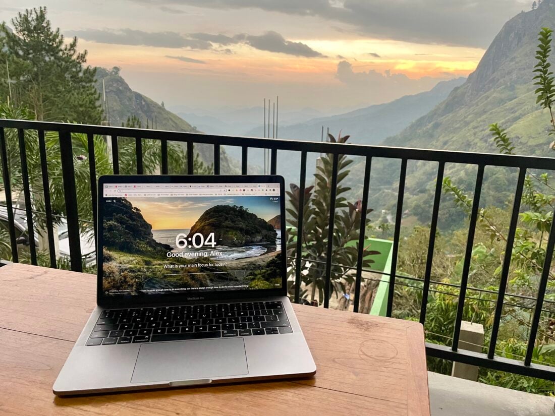 remote worker digital nomad destination, beautiful mountain backdrop views and laptop on desk