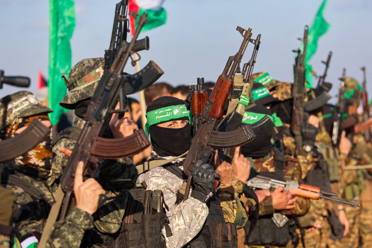 Ranks of Hamas fighters formed up on Gaza's beachfront on February 1 for the handover of an Israeli-American hostage Keith Siegel in a show of force against the dramatic backdrop of breaking waves.