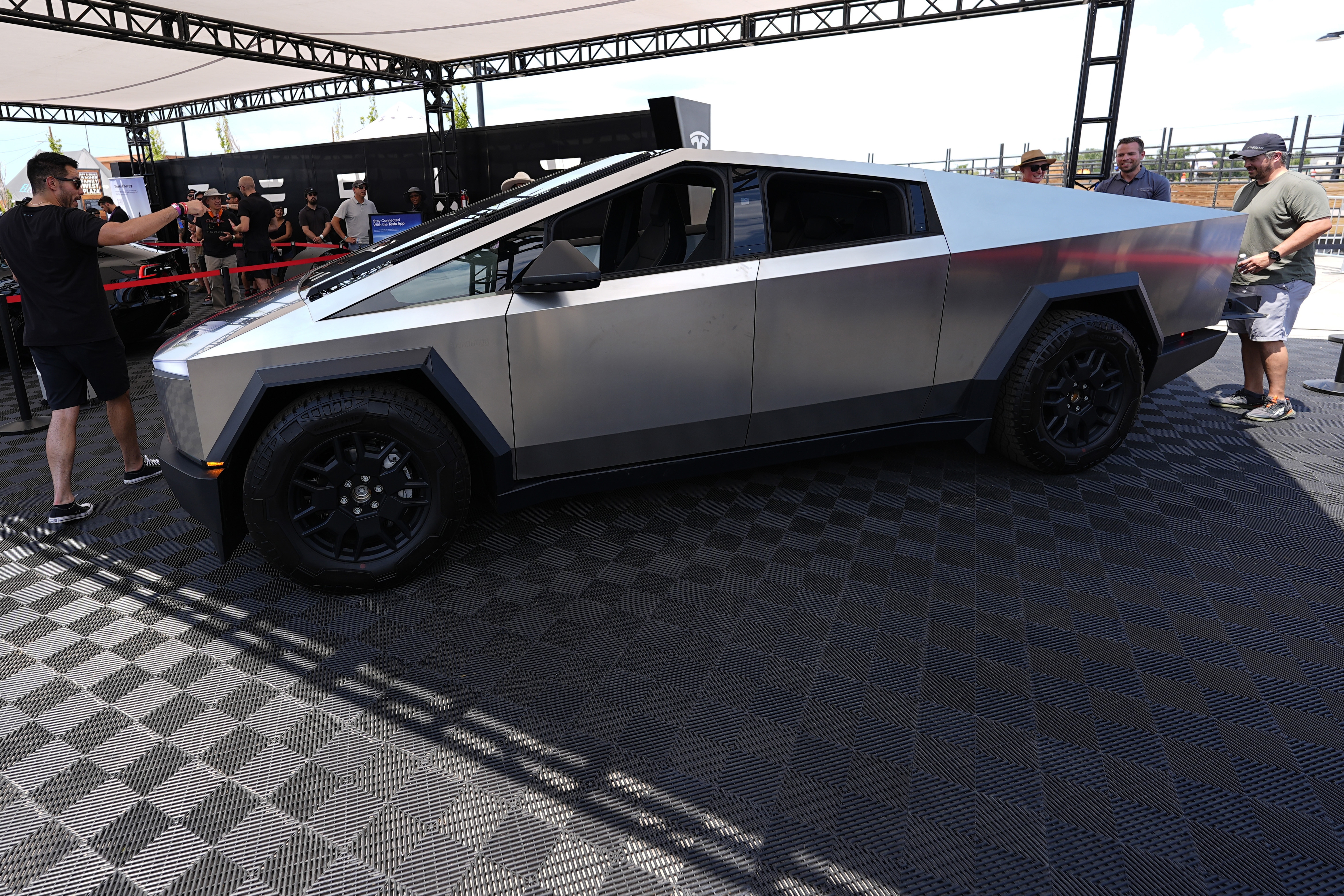 Visitors look over a 2024 Cybertruck in the Tesla display at the Electrify Expo, last July.